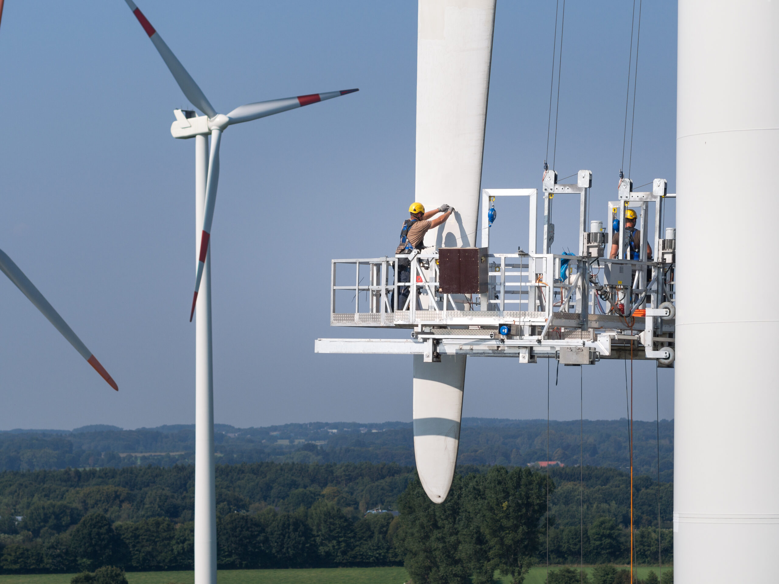 Workers,On,A,Hanging,Platform,Repair,A,Damaged,Rotor,Blade